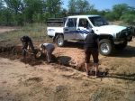 Digging trenches and packing rocks for erosion control